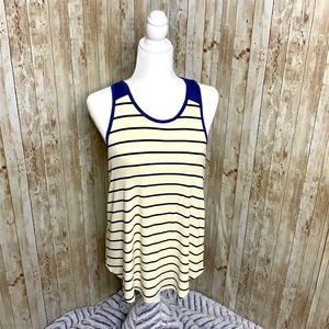 Cream colored striped racer back tank top with denim blue detail on top